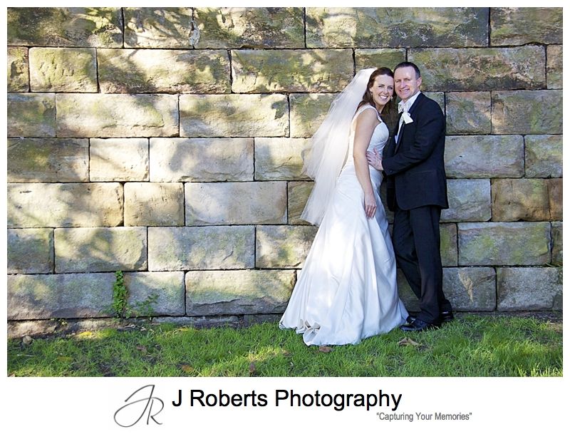 Portrait of a couple in front of sandstone wall Jeffery St Wharf - wedding photography sydney